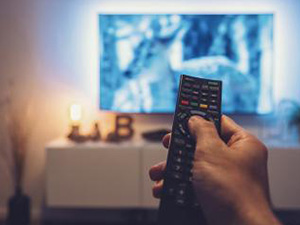 man Watching movie and using remote control : Stockfoto oder Stockvideo und Fotos, Bilder, Stockmedien von rcfotostock | RC-Photo-Stock